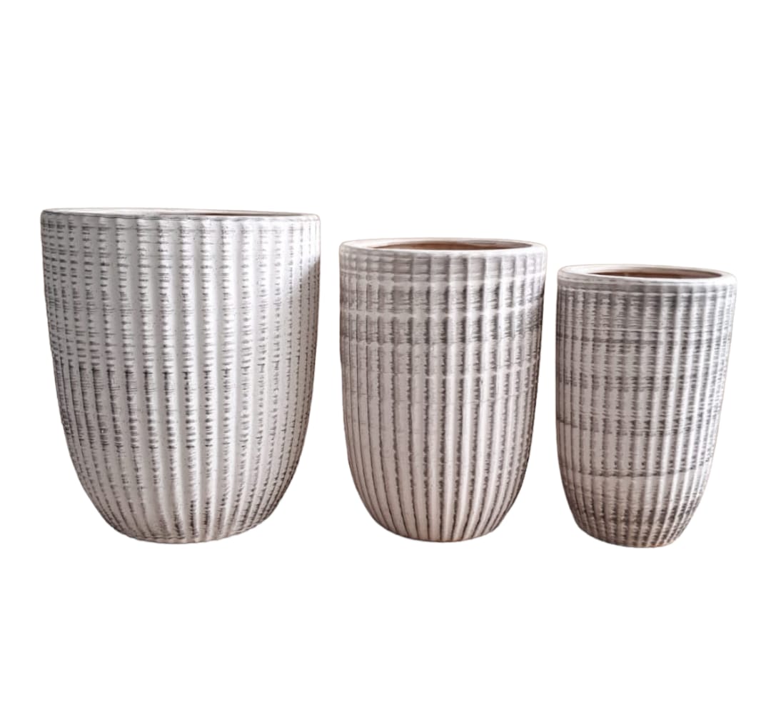 Set of three textured white ceramic plant pots in varying sizes on white background