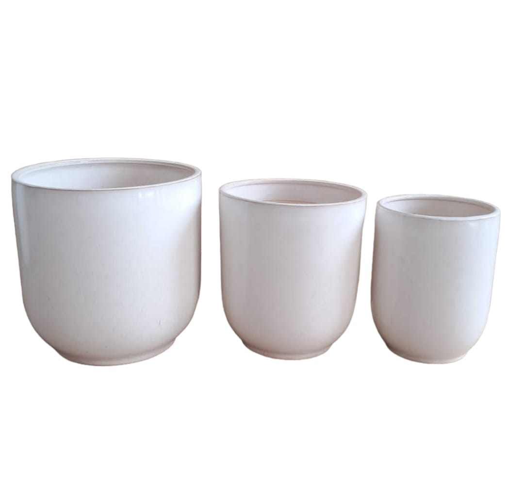 Set of three white ceramic plant pots in different sizes, minimalist style.