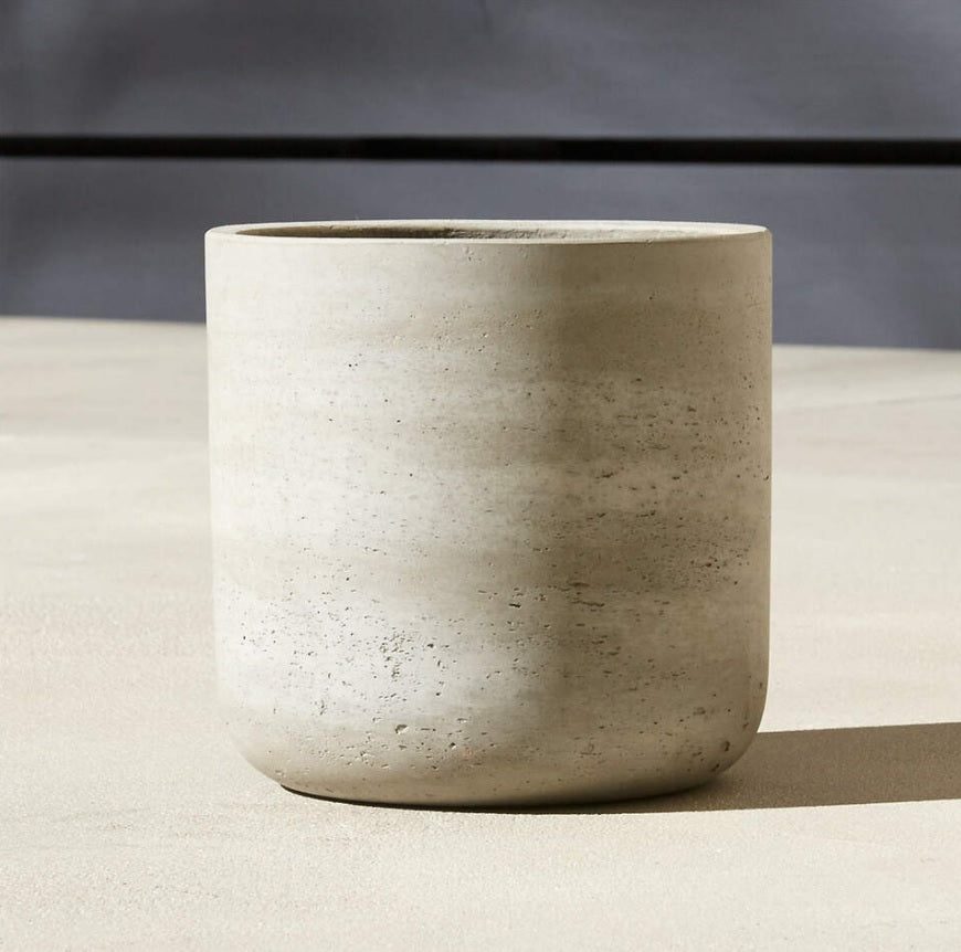 Minimalist beige fiber cement plant pot with smooth texture on a neutral background