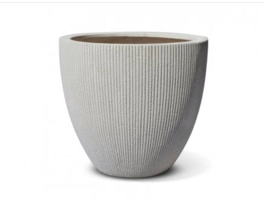 Modern textured ceramic plant pot with vertical grooves on a white background
