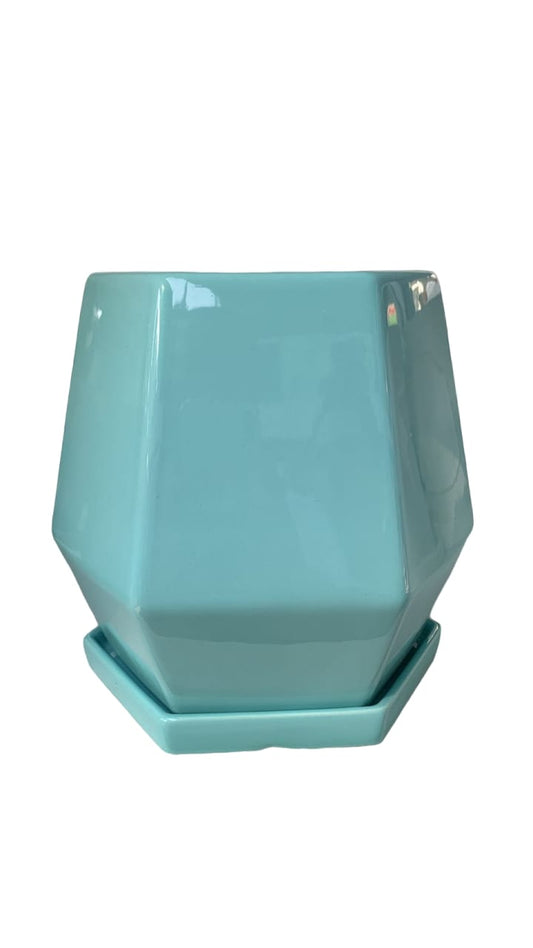 Turquoise geometric ceramic plant pot with matching saucer, ideal for indoor plants.