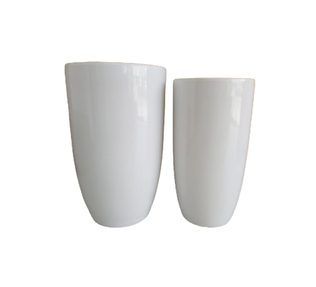 Two tall white ceramic planters with a glossy finish on a plain background