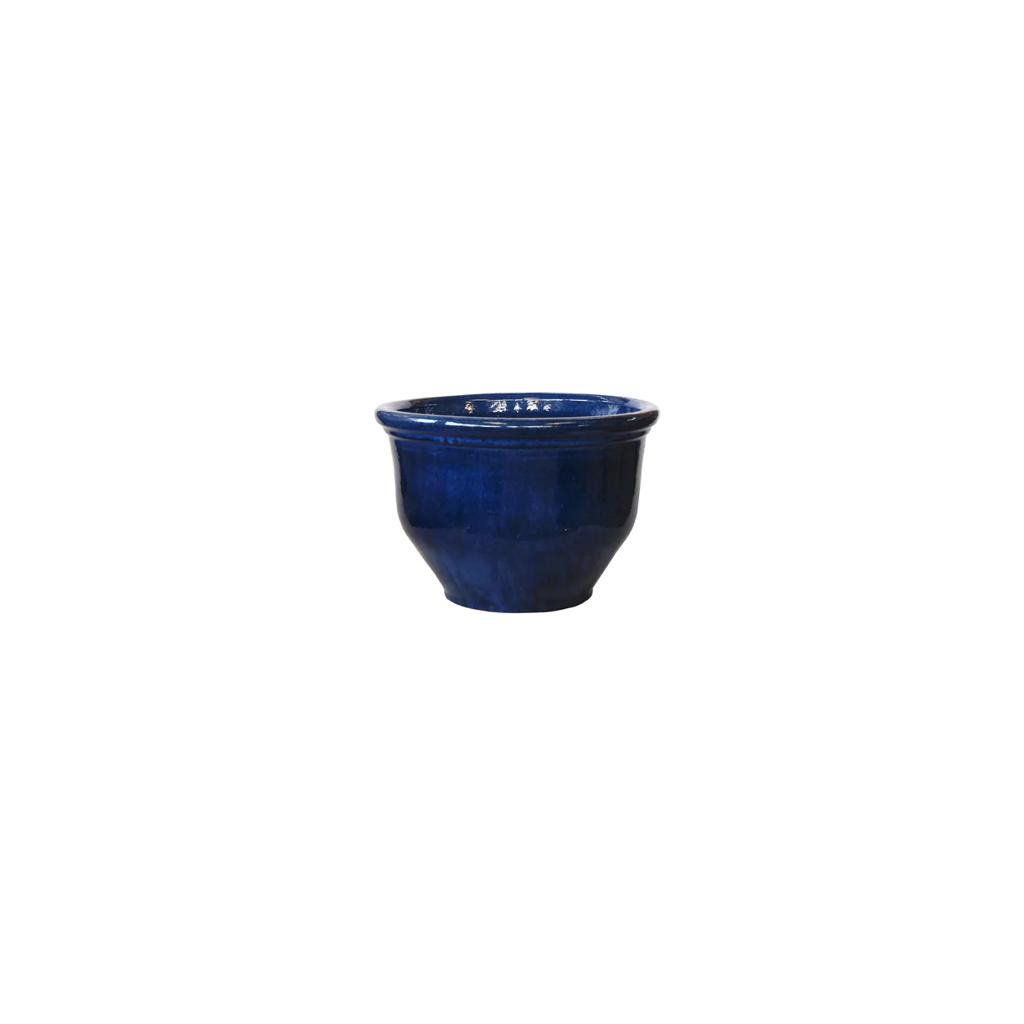 Glossy blue ceramic plant pot with flared rim on white background