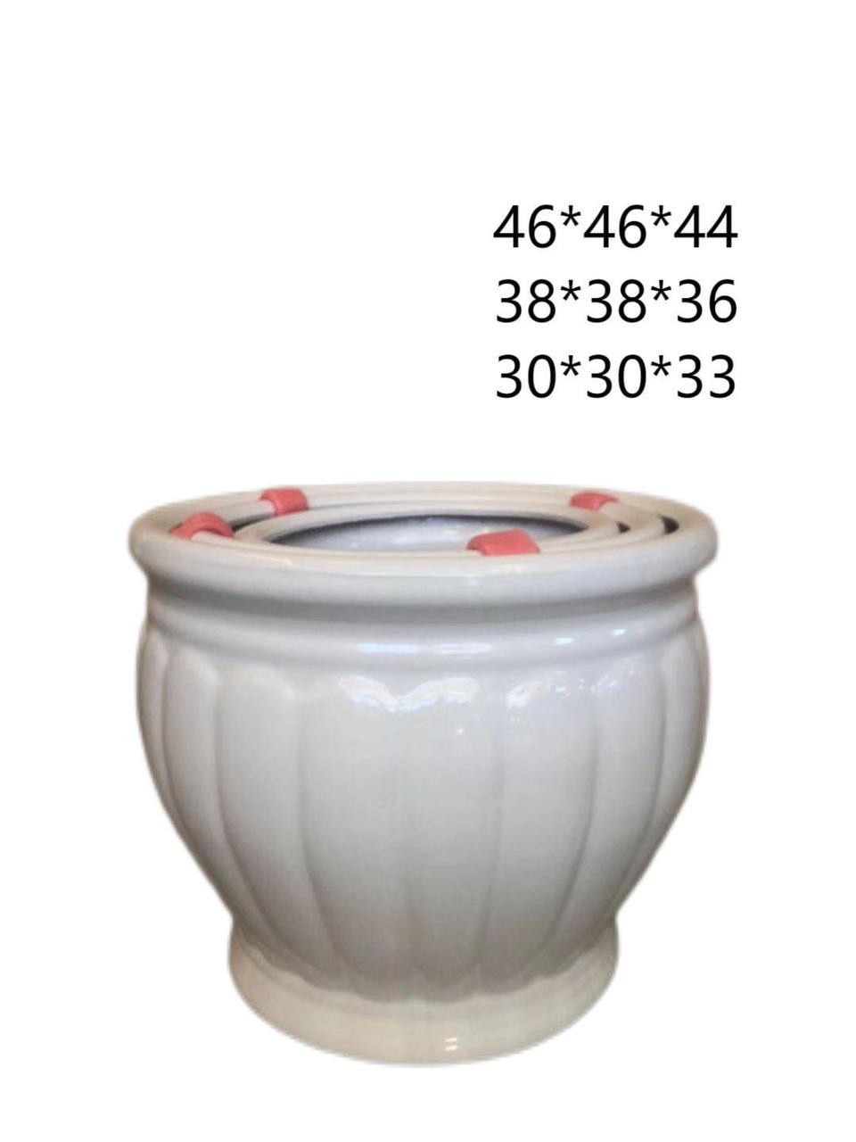 Set of three white ceramic plant pots in different sizes with ribbed design and size labels.